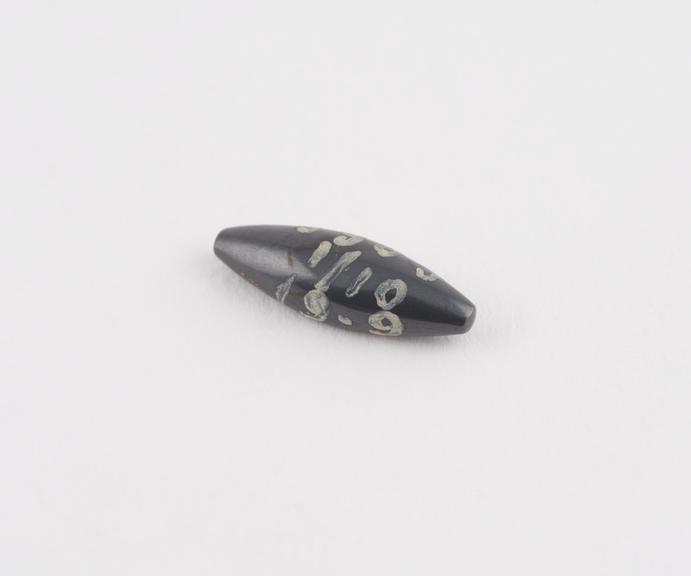 One of 3 black haematite Syrian weights, barrel shaped