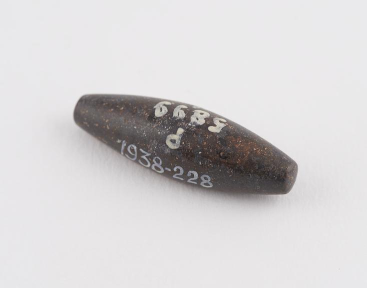 One of 3 black haematite Syrian weights, barrel shaped