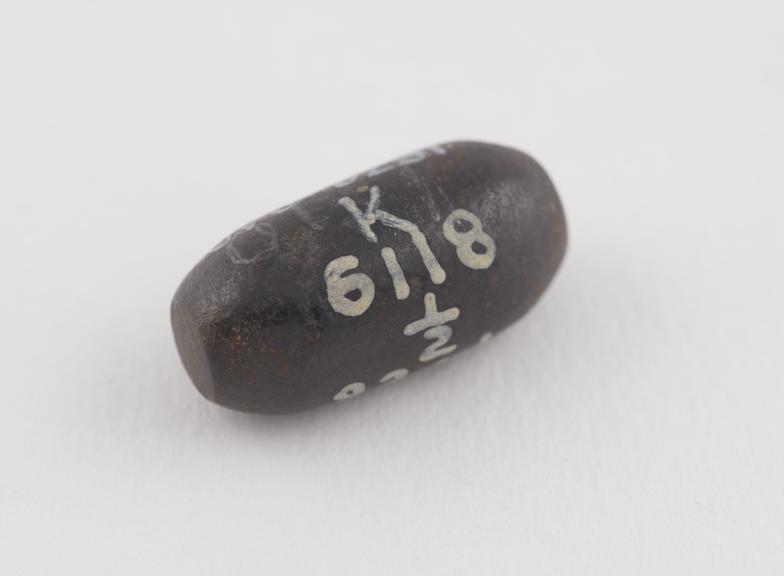 One of  2 brown haematite Syrian weights, barrel shaped