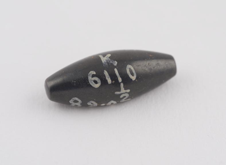 One of 3 black haematite Syrian weights, barrel shaped