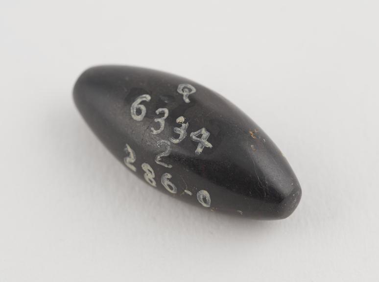 One of 9 black haematite Syrian weights, barrel shaped