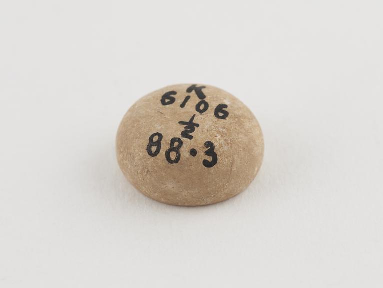 One of 2 limestone Syrian weights, ovoid and circular