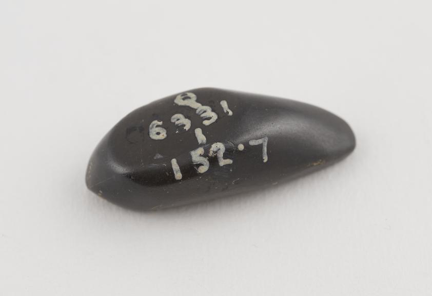 One of 9 black haematite Syrian weights, barrel shaped