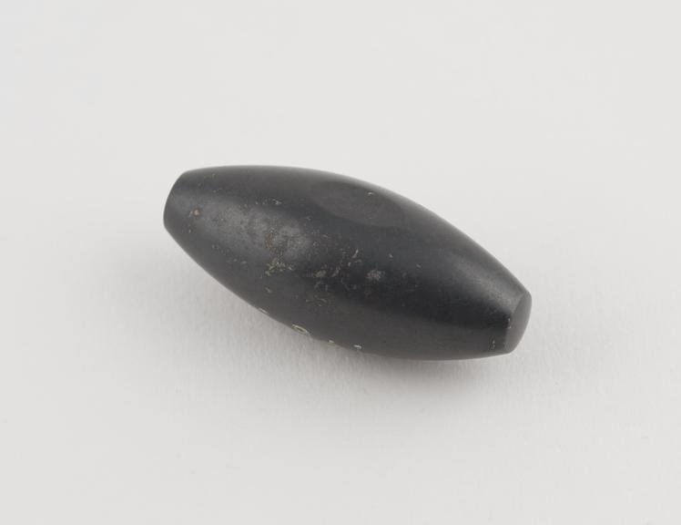 One of 9 black haematite Syrian weights, barrel shaped