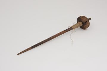 Wooden spindle with spun flax thread