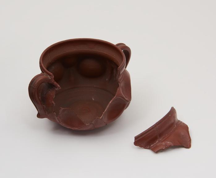 Pottery Roman drinking bowl, red glazed, (incomplete)