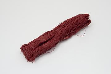 Red coloured hank of satin carpet thread