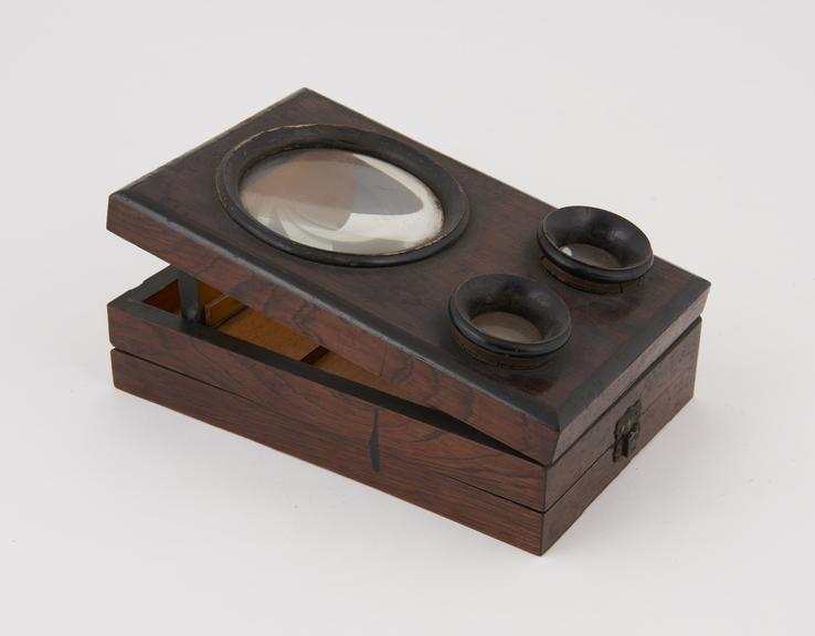 Fold up' stereoscopic viewer housing a magnifying lens and