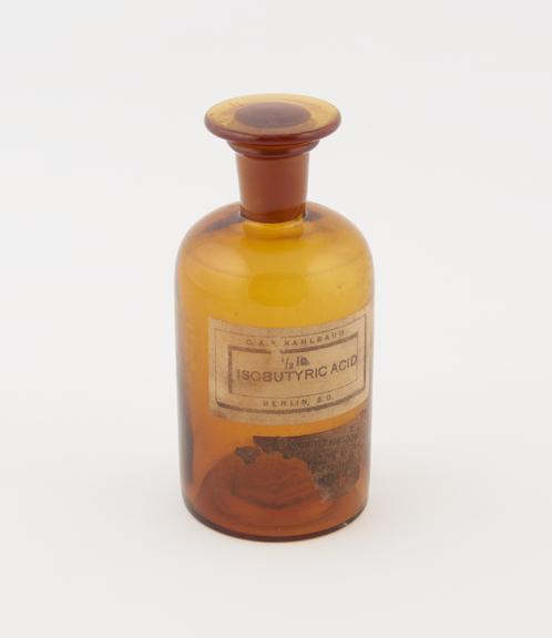 Isobutyric acid bottle (contents removed) supplied by Kahlbaum