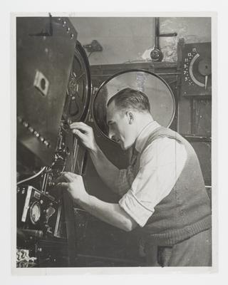 Photograph of a projectionist at work