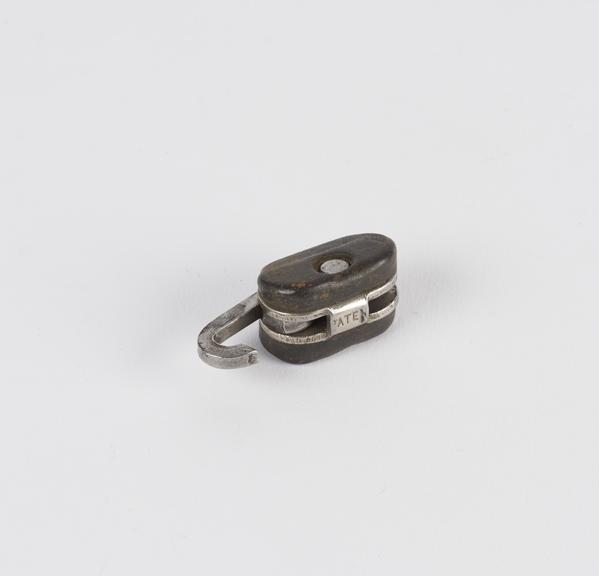 Metal and leather belt fastener with the word 'Paten' stamped