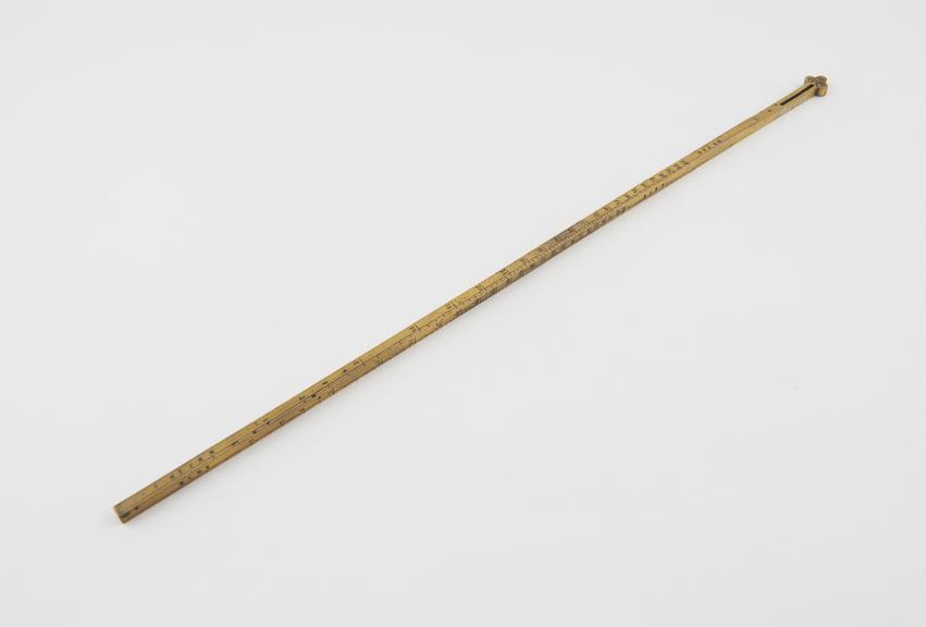 One of two measuring brass, gilt rods