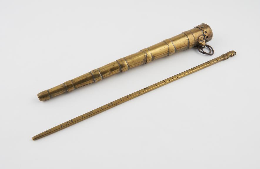 Brass measuring rod about 12.23 and brass case for carrying rod