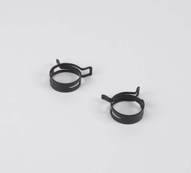 Two flat steel spring clips
