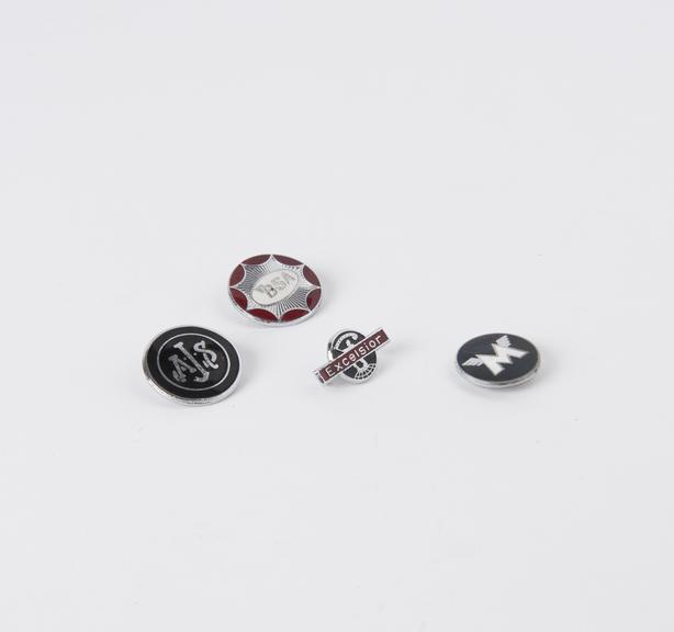 Four metal motorcycle brand pin badges