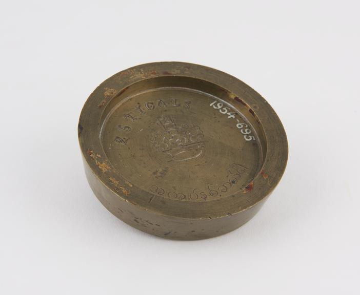 One of three Indian circular saucer shape weights  from a set