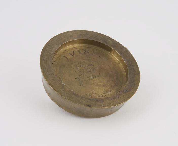 One of three Indian circular saucer shape weights  from a set