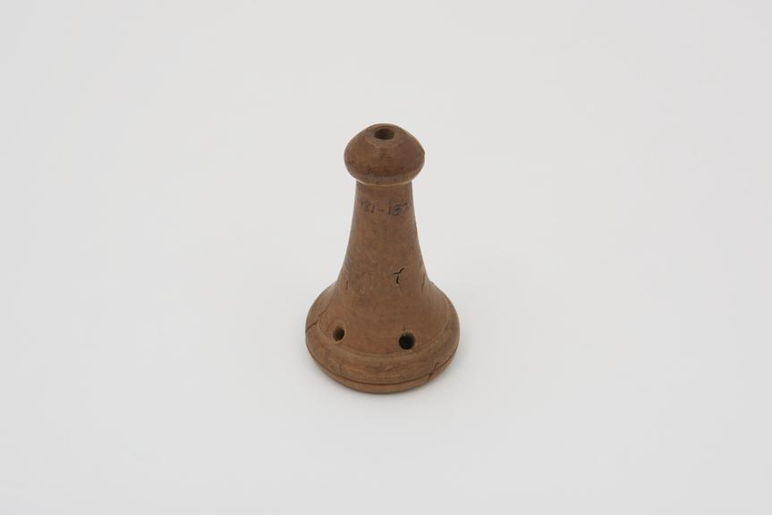 Wooden pie funnel, conical shape with crudely carved holes