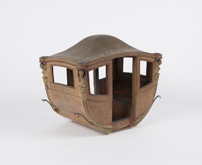 Model of coach body with winged female figure at each corner