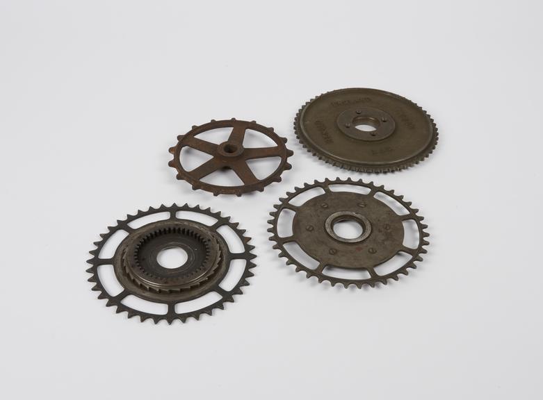 Group of four bicycle crank wheels.
