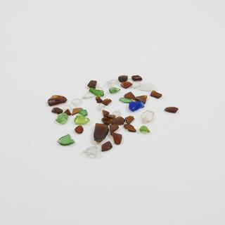 Fragments of green, brown, clear and blue glass from recycling sorting machines