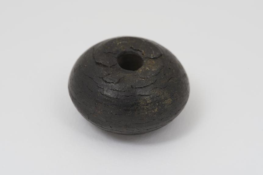 Spindle whorl of turned shale, of Roman date