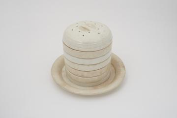 White glazed earthenware cheese ring press