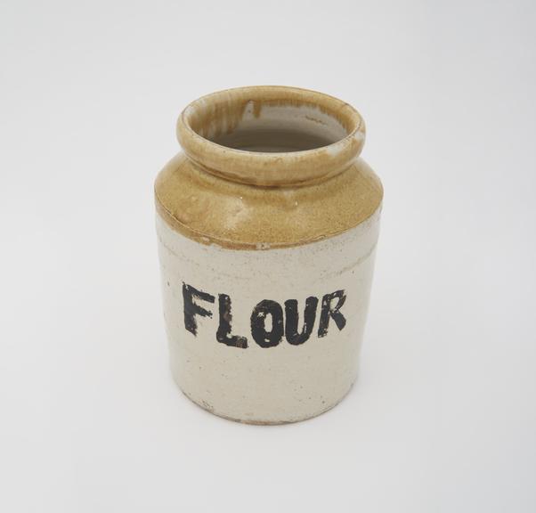 One of three, eathenware storage jars marked, 'FLOUR', unsigned