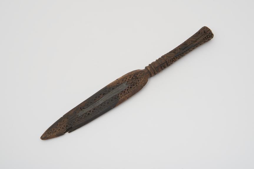 Small carved wooden weft beater, in the shape of a knife