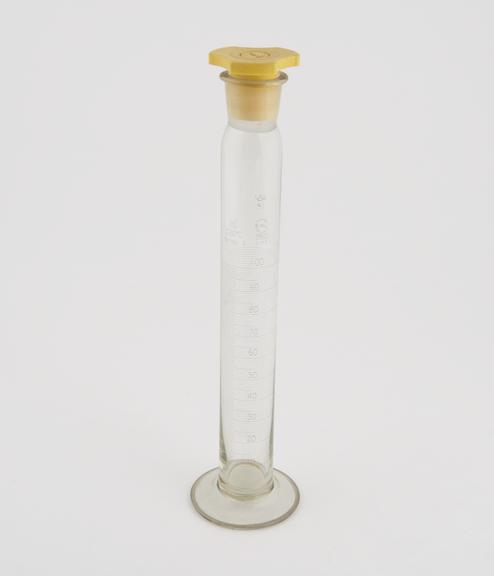 Glass cylinder, 100ml, with polythene stopper and N.P.L. certificate