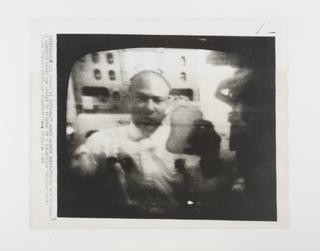 Photograph of Edwin E. 'Buzz' Aldrin showing how to make a sandwich in space