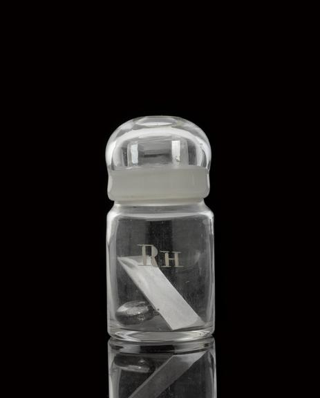 Glass-stoppered bottle containing rhodium