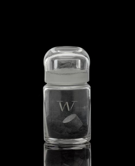 Glass-stoppered bottle containing tungsten