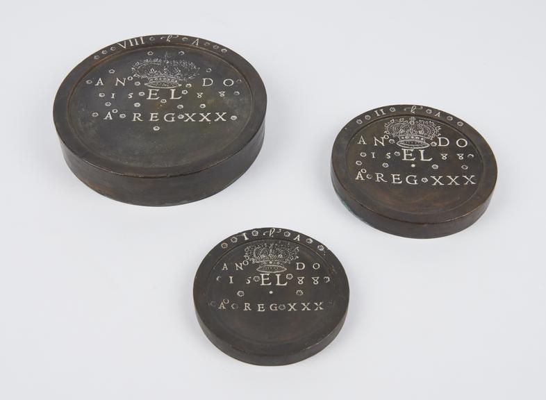 Electrotype copy of a set of three flat circular weights