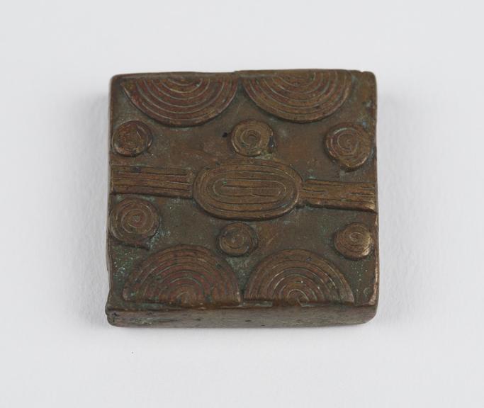 One of 84 Ashanti  brass weights in the form of a square tablet