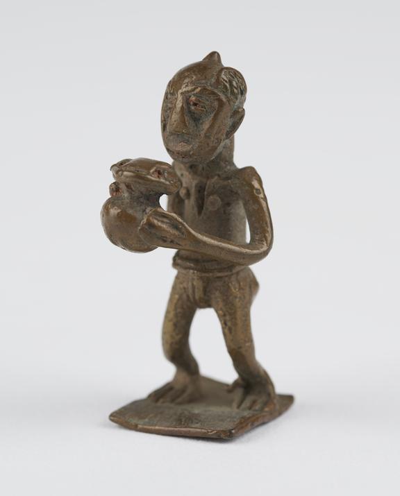 One of 84 Ashanti  brass weights in the form of a man carrying