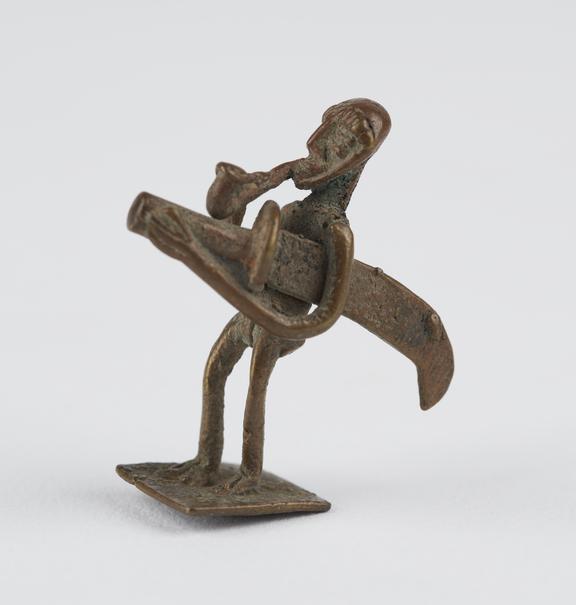 One of 84 Ashanti  brass weights in the form of a man smoking a