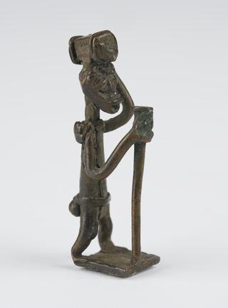 Ashanti weight in the form of a man carrying a parcel on his head