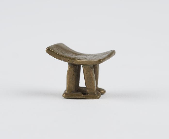 One of 84 Ashanti  brass weights in the form of a stool.