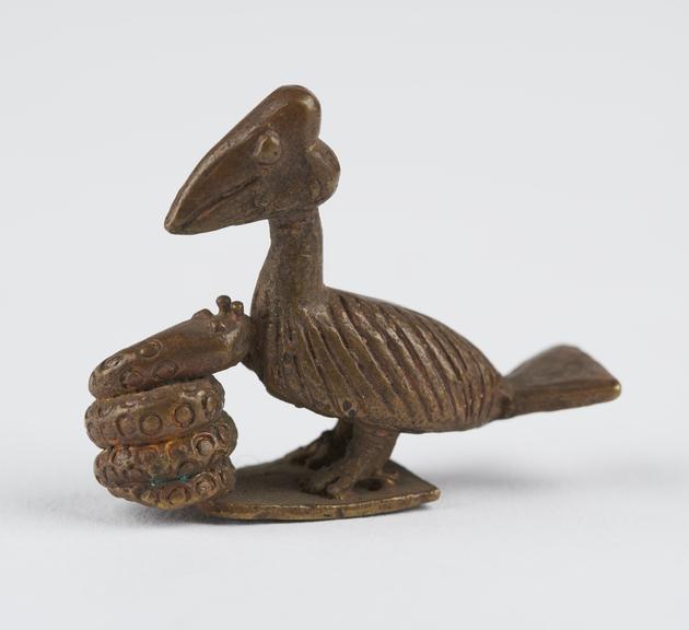 One of 84 Ashanti  brass weights in the form of a bird being