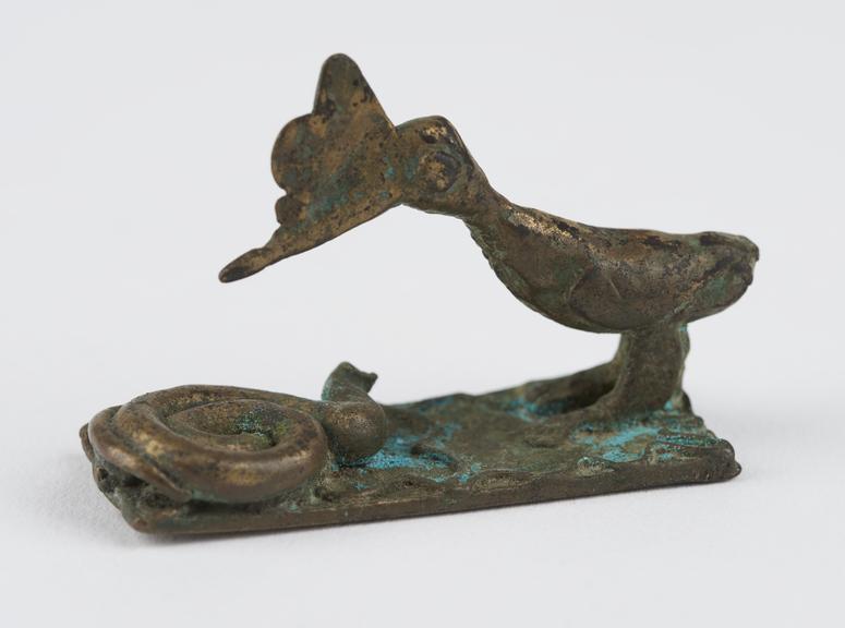 One of 84 Ashanti  brass weights in the form of a bird with a