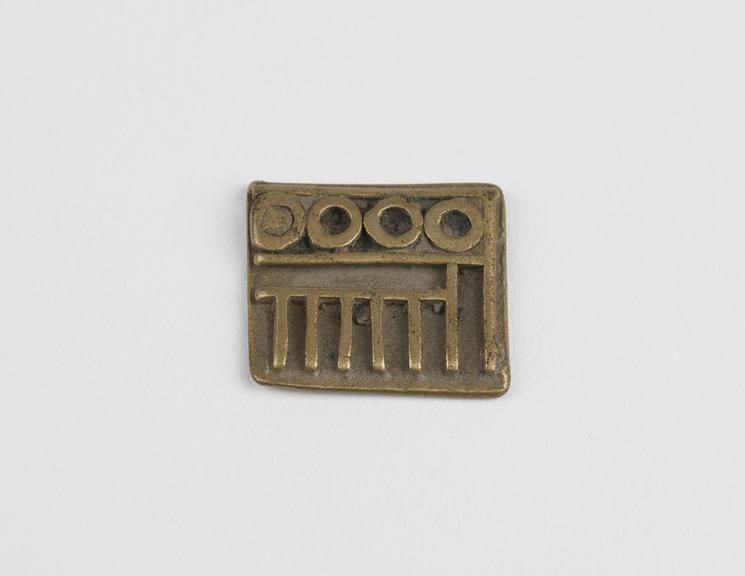 One of 84 Ashanti  brass weights in the form of a rectangular