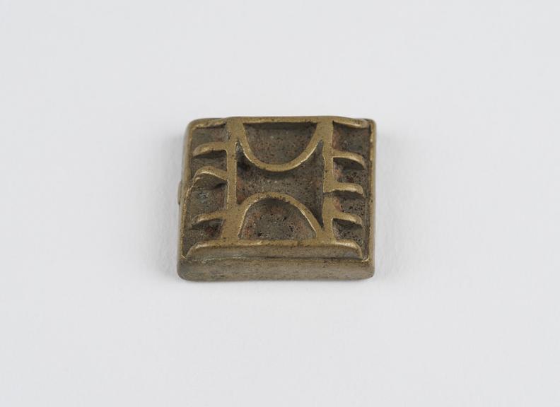 One of 84 Ashanti  brass weights in the form of a square tablet