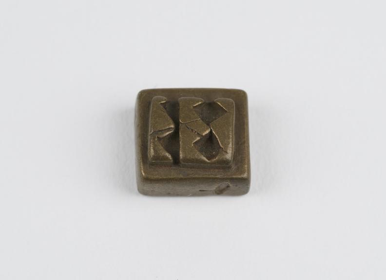 One of 84 Ashanti  brass weights in the form of a square tablet