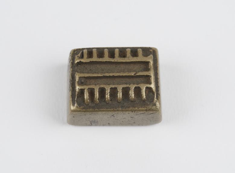 One of 84 Ashanti  brass weights in the form of a rectangular