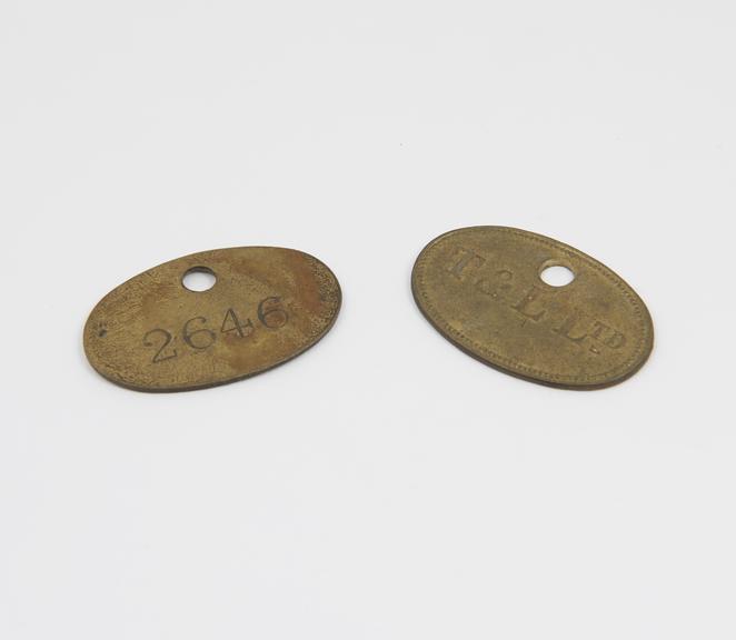 Two brass pay tags issued by Tate & Lyle to suppliers of raw