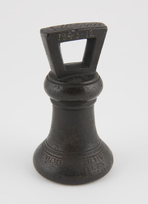 One of two avoirdupois bronze bell shaped weights with solid