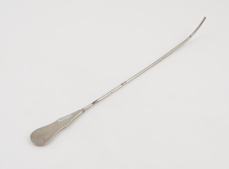 Small curved lithotomy staff with median groove and flat handle