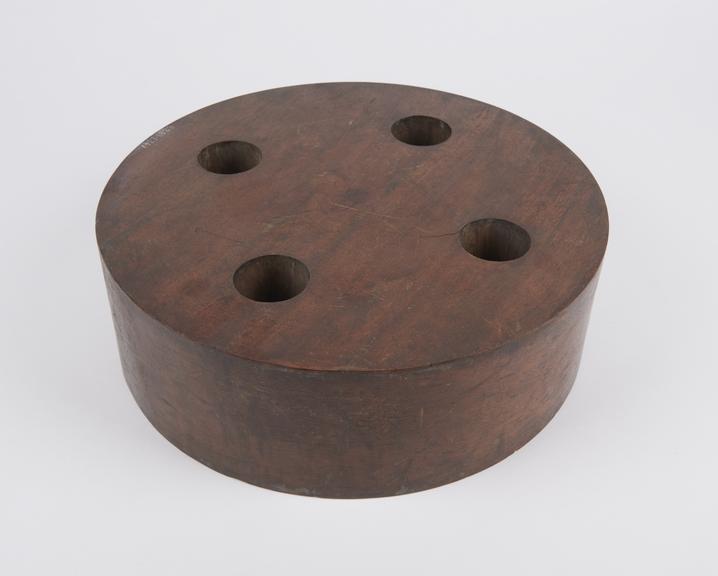 Cylindrical block with four vertical equidistant holes