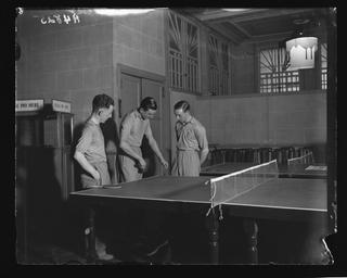 Tennis star Fred Perry plays table tennis